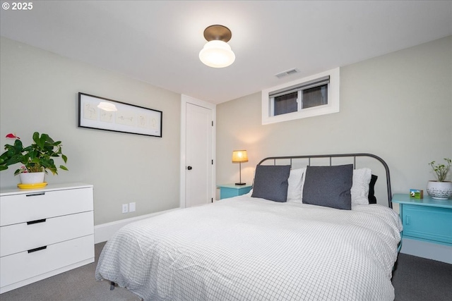 carpeted bedroom featuring visible vents