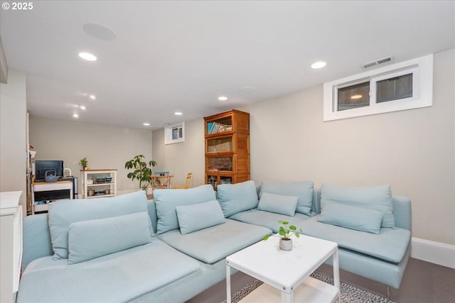 living area with recessed lighting, visible vents, and baseboards