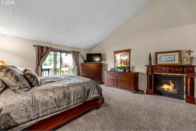 carpeted bedroom with access to outside, a textured ceiling, lofted ceiling, and a fireplace with flush hearth
