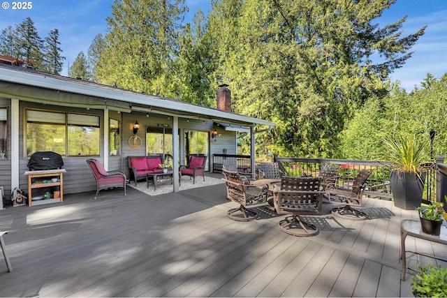 wooden terrace with outdoor dining space and an outdoor hangout area
