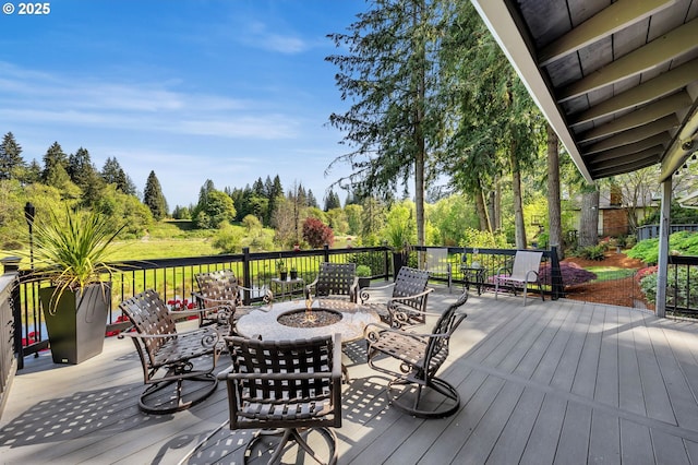 wooden deck featuring a fire pit