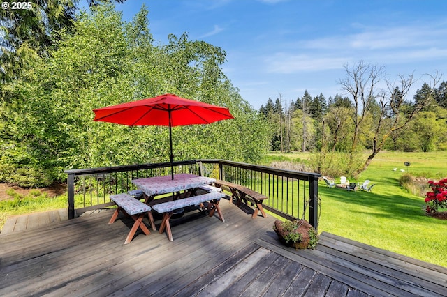 wooden terrace with a lawn and outdoor dining space