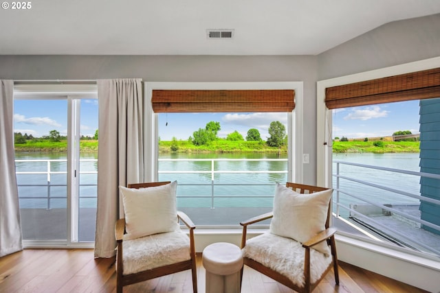 sunroom / solarium featuring a water view and visible vents