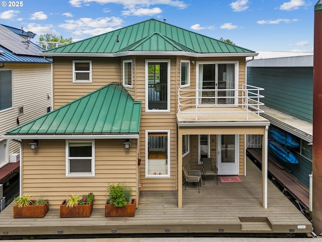 back of house featuring metal roof and a standing seam roof