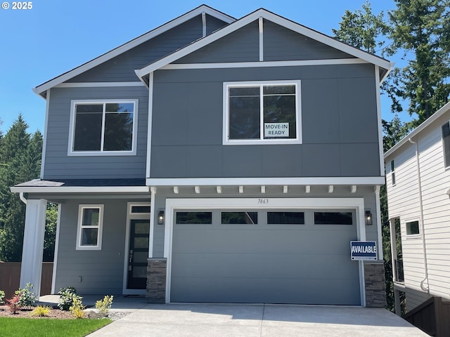 7863 SW Thornbridge Ter Unit 11, Beaverton, OR 97007 - view of front of property with concrete driveway, a garage, a porch, and stone siding