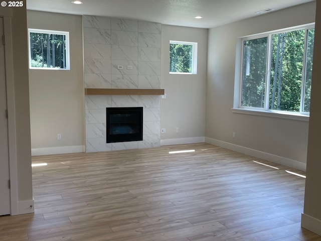 7863 SW Thornbridge Ter Unit 11, Beaverton, OR 97007 - unfurnished living room with baseboards, recessed lighting, a premium fireplace, and wood finished floors