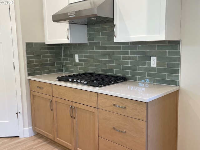 7863 SW Thornbridge Ter Unit 11, Beaverton, OR 97007 - kitchen with range hood, light countertops, stainless steel gas cooktop, and tasteful backsplash
