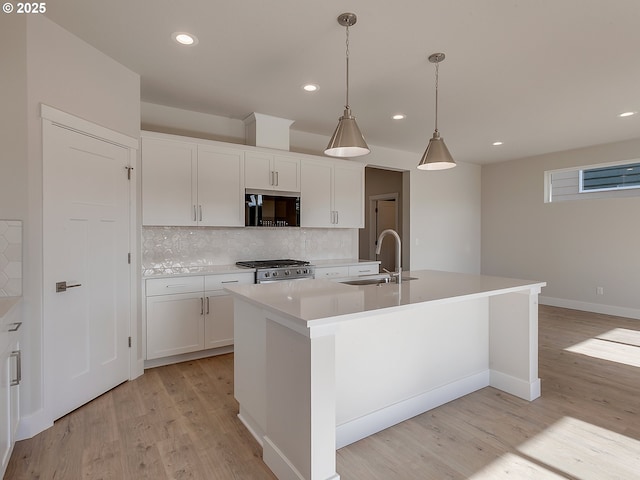 13859 SW Sabrina Ave, Tigard, OR 97140 - kitchen featuring a sink, black microwave, range, decorative backsplash, and white cabinets