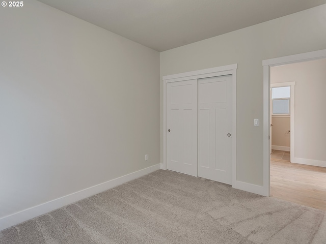 13859 SW Sabrina Ave, Tigard, OR 97140 - unfurnished bedroom with baseboards, light carpet, and a closet