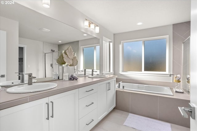 bathroom featuring vanity, shower with separate bathtub, and tile patterned flooring