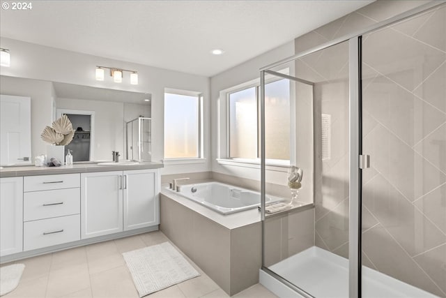 bathroom featuring vanity, tile patterned flooring, and shower with separate bathtub