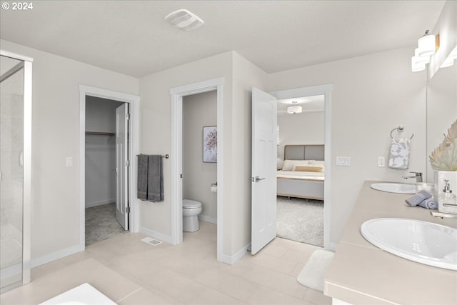 bathroom with vanity, tile patterned floors, and toilet