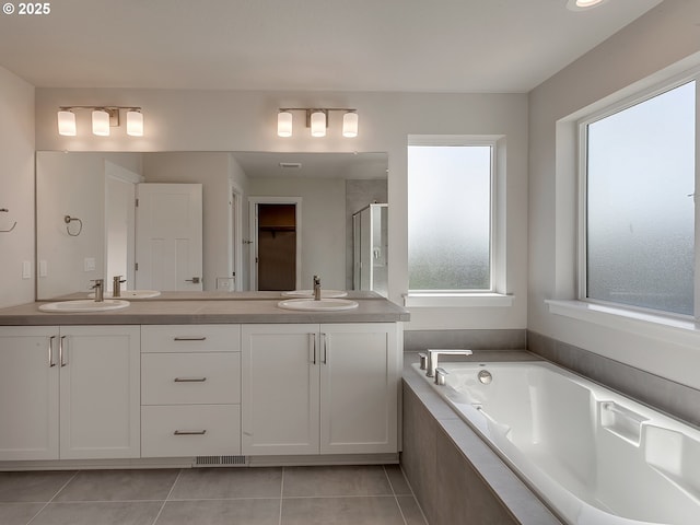 13859 SW Sabrina Ave, Tigard, OR 97140 - full bathroom featuring a stall shower, double vanity, a bath, tile patterned floors, and a closet