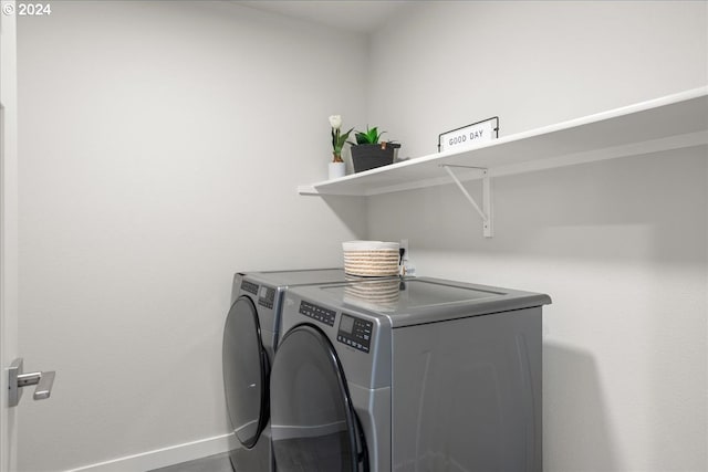 clothes washing area with washer and clothes dryer