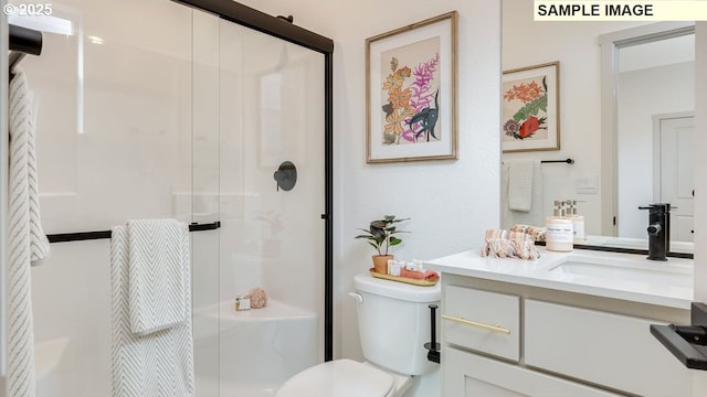 full bath featuring vanity, a shower stall, and toilet