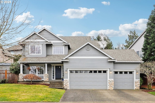 craftsman house with a garage, covered porch, and a front lawn