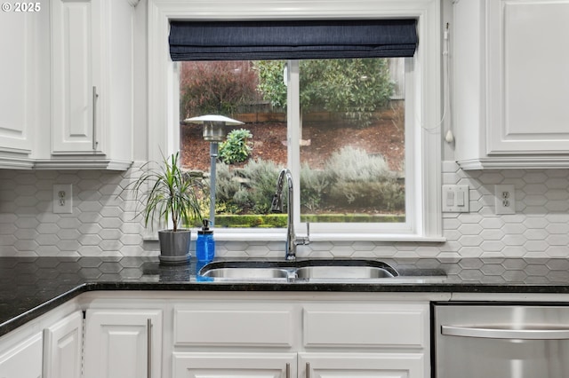 kitchen with white cabinets, dishwasher, sink, and decorative backsplash