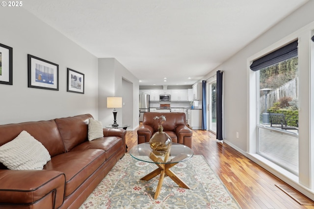 living room with light hardwood / wood-style flooring