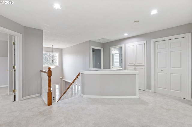 unfurnished room with a notable chandelier and light carpet