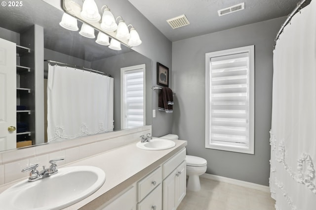 16374 SE Orchard View Ln, Damascus, OR 97089 - full bath with double vanity, toilet, baseboards, and a shower with shower curtain