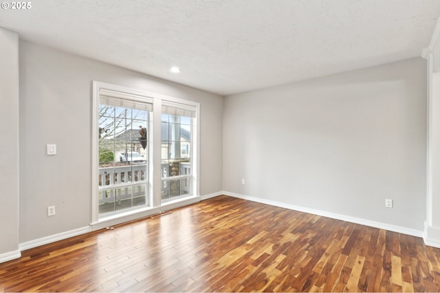 empty room with hardwood / wood-style floors