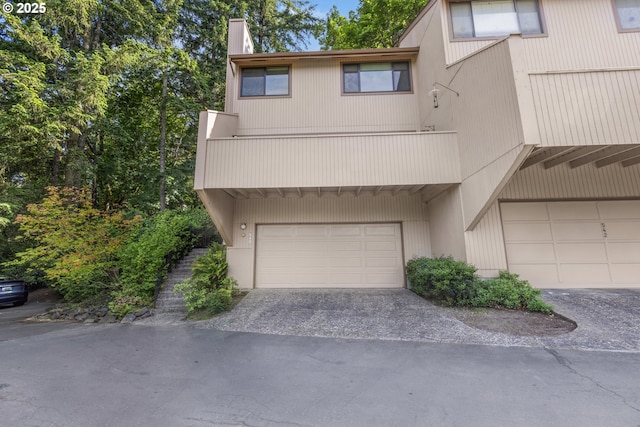 540 Montara Way, Eugene, OR 97405 - townhome / multi-family property with a garage, a chimney, and driveway