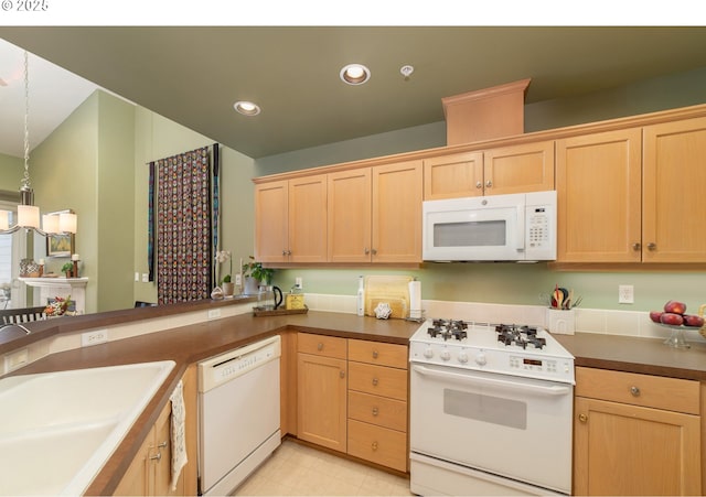 kitchen with white appliances, light brown cabinets, recessed lighting, a sink, and decorative light fixtures