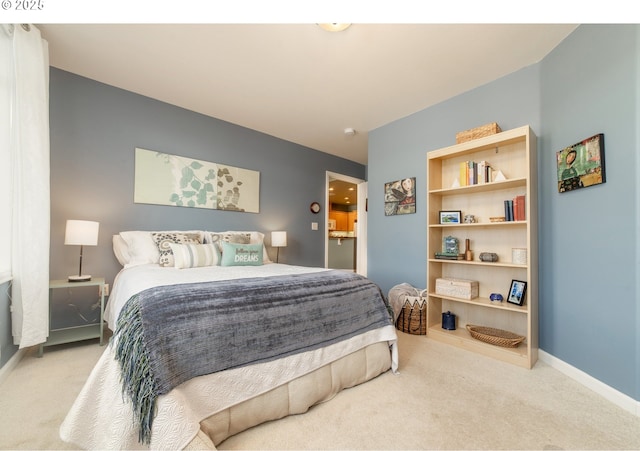 bedroom featuring carpet and baseboards