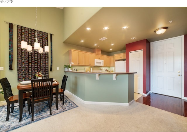 dining space featuring a chandelier, recessed lighting, baseboards, and dark colored carpet