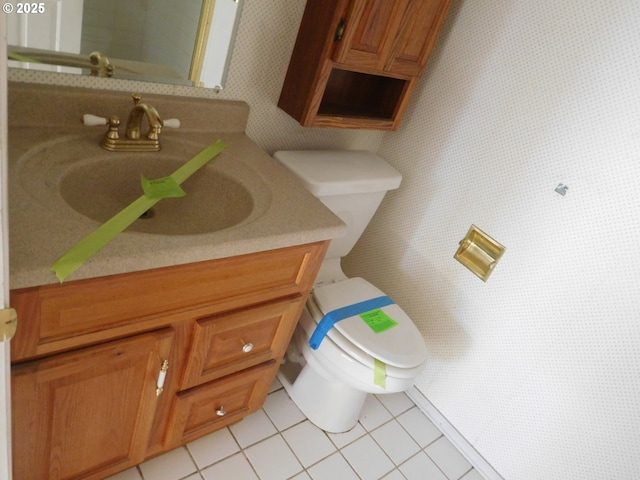 bathroom featuring tile patterned flooring, vanity, and toilet