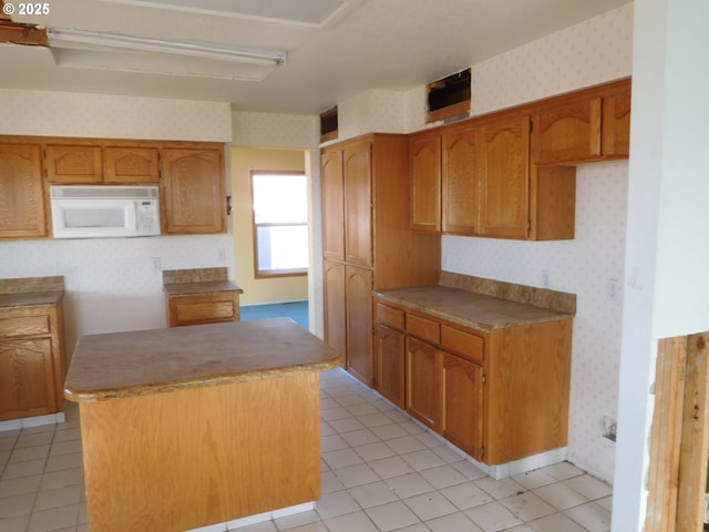 kitchen featuring light tile patterned flooring and a kitchen island