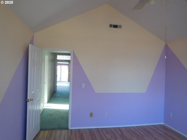 additional living space featuring ceiling fan, vaulted ceiling, and hardwood / wood-style floors