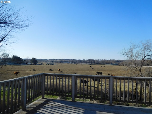 wooden deck featuring a rural view