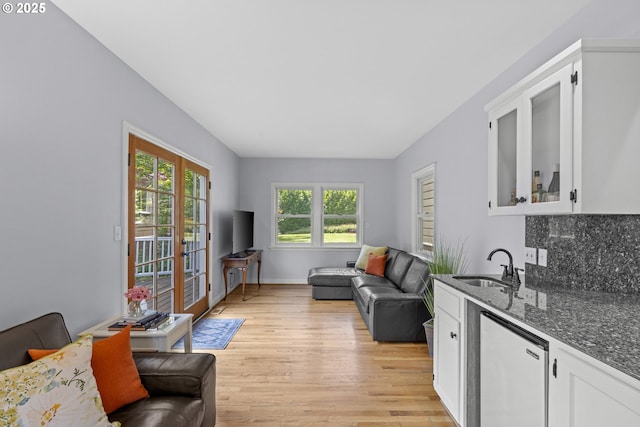 5707 SW Menefee Dr, Portland, OR 97239 - living room featuring light wood-style flooring and bar with sink