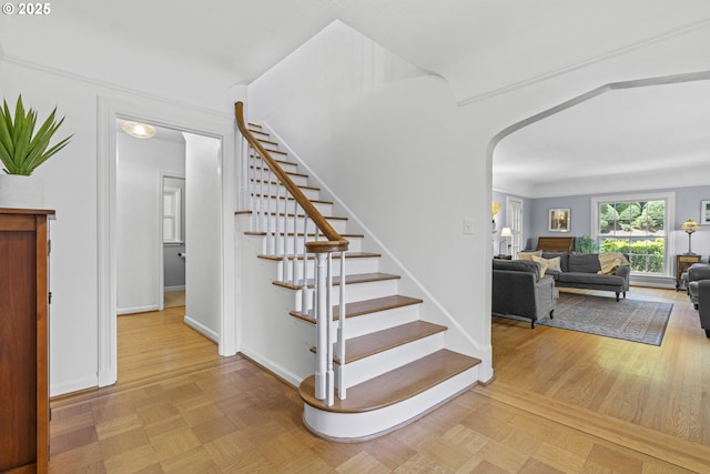 5707 SW Menefee Dr, Portland, OR 97239 - stairs featuring arched walkways and baseboards
