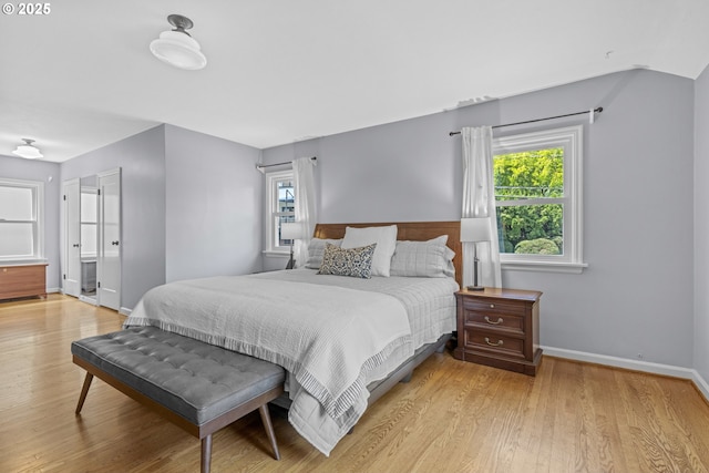 5707 SW Menefee Dr, Portland, OR 97239 - bedroom with light wood-style floors and multiple windows