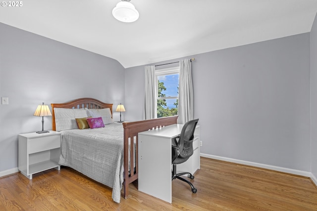 5707 SW Menefee Dr, Portland, OR 97239 - bedroom with wood finished floors, vaulted ceiling, and a desk