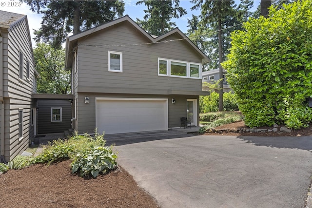 5707 SW Menefee Dr, Portland, OR 97239 - view of front of home featuring a garage and driveway
