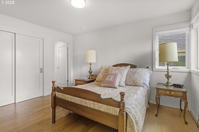 5707 SW Menefee Dr, Portland, OR 97239 - bedroom with light wood-style floors and a closet
