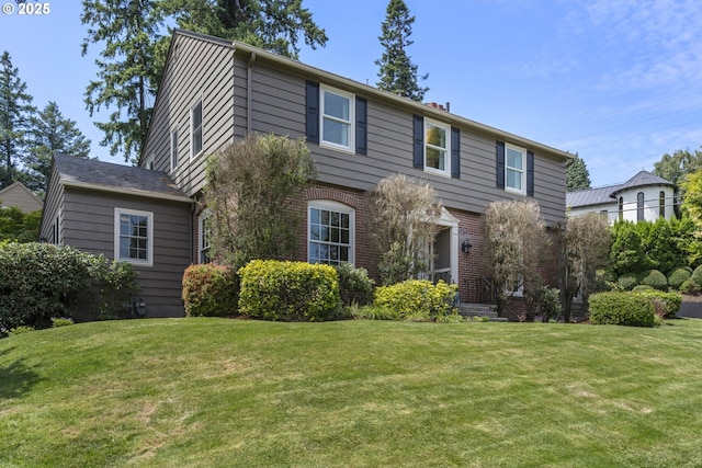 5707 SW Menefee Dr, Portland, OR 97239 - view of front of home with a front lawn and brick siding