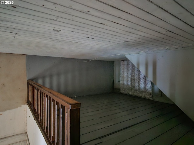 additional living space with wood-type flooring and wooden ceiling