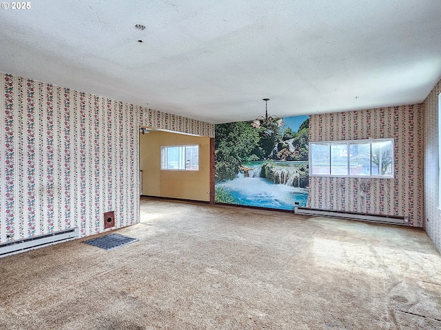 unfurnished dining area featuring a wealth of natural light, a textured ceiling, and baseboard heating