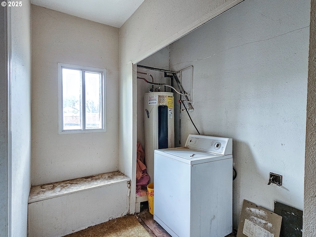 laundry room with water heater and washer / dryer