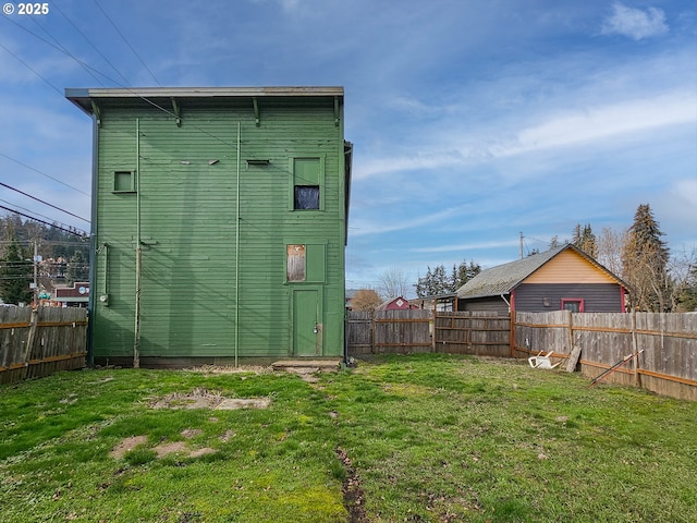 back of property featuring a lawn