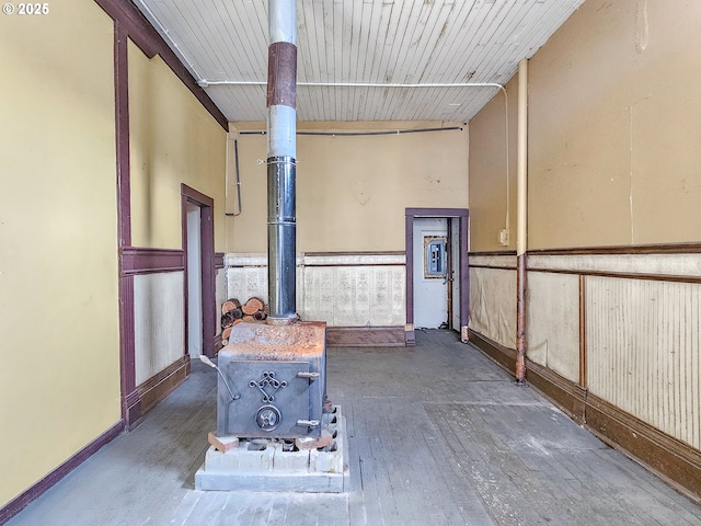 interior space featuring wood ceiling, dark hardwood / wood-style flooring, and a wood stove