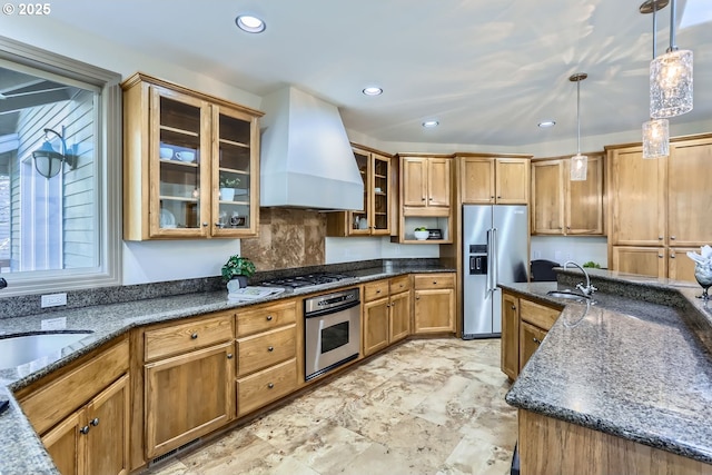 kitchen with pendant lighting, sink, custom exhaust hood, and appliances with stainless steel finishes