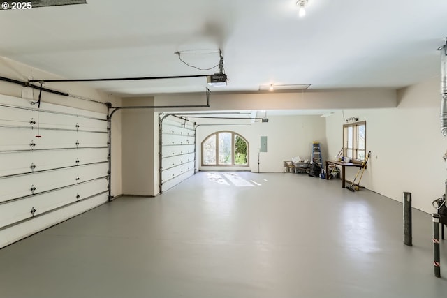 garage featuring a garage door opener and electric panel