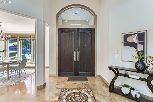 entryway featuring a chandelier