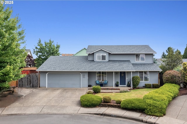4931 NE Mink Ct, Salem, OR 97305 - traditional-style house with an attached garage, a porch, driveway, and a shingled roof