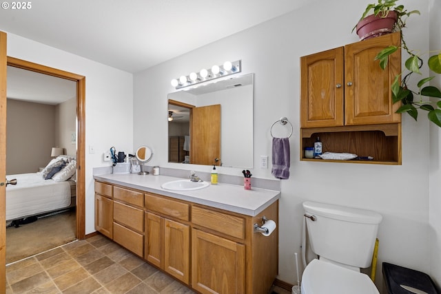 4931 NE Mink Ct, Salem, OR 97305 - ensuite bathroom featuring vanity, stone finish flooring, and a ceiling fan